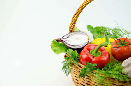 Vegetables and herbs in a wicker basketの写真素材