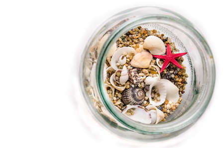 Sea sand and shellfish in glass containersの写真素材