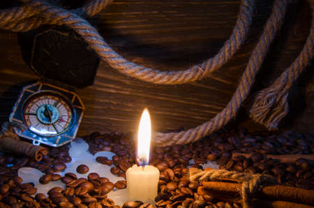 Coffee and cinnamon rolls by candlelightの写真素材