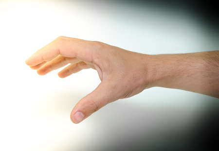 Human hand from the darkness to the lightの写真素材