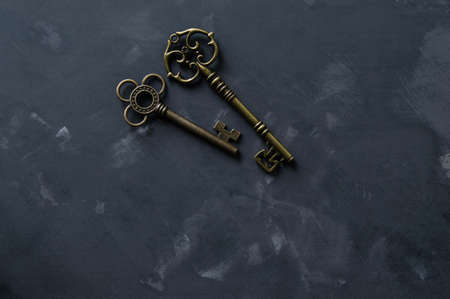 Vintage bronze keys on the concrete surfaceの写真素材