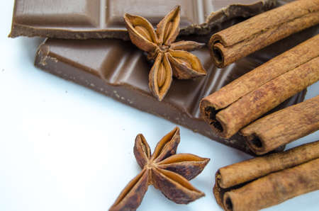 Milk chocolate, cinnamon sticks and star aniseの写真素材