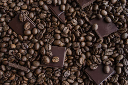 Broken slices of chocolate and coffee beansの写真素材