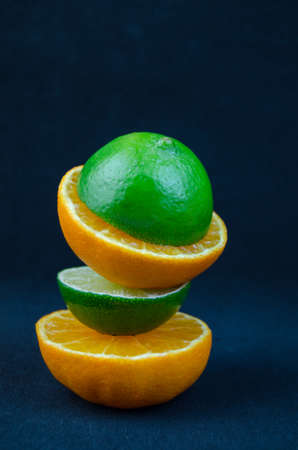 The fruit of lime and mandarin cut in half.の写真素材
