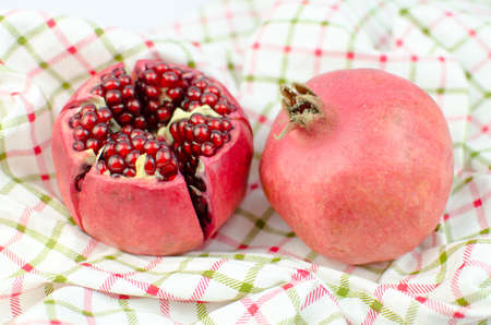 Pomegranate fruit on a napkin.