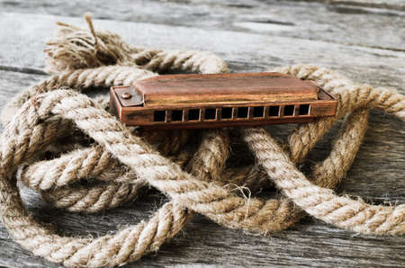 Harmonica on a wooden tableの写真素材