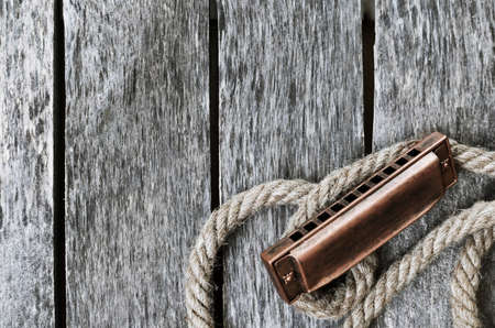 Harmonica on a wooden tableの写真素材