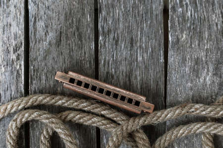 Harmonica on a wooden tableの写真素材