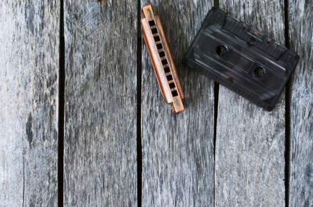 Harmonica and an old audio cassette tapeの写真素材