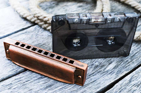Harmonica and an old audio cassette tapeの写真素材