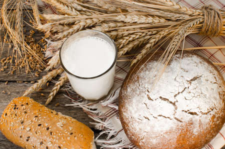 Loaf of black bread on old wooden table, the rays of the morning sunの写真素材