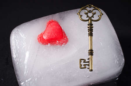 Heart and key frozen in a block of iceの写真素材