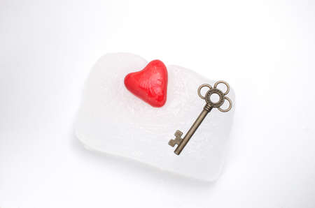 Heart and key frozen in a block of iceの写真素材