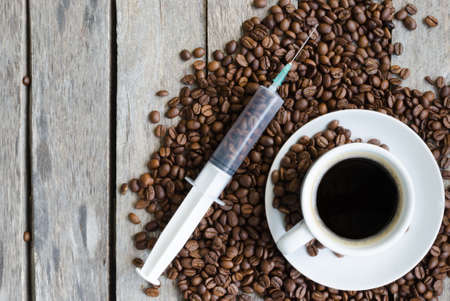 Syringe, a Cup of coffee and coffee beans