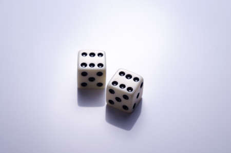 Playing white dice on a light background closeupの写真素材