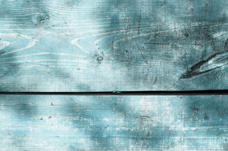 Texture of the wood painted in blue with the shadows of the treesの写真素材