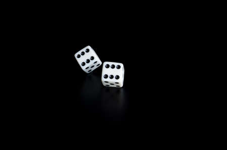 Thrown the dice on black background with reflectionの写真素材
