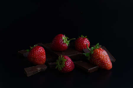 Berry strawberry in the chocolate on black background