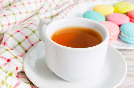 Cup of tea and cake and French macaroonsの写真素材