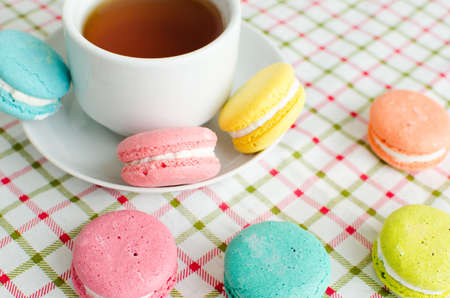 Cup of tea and cake and French macaroonsの写真素材