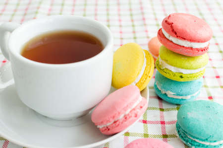 Cup of tea and cake and French macaroonsの写真素材