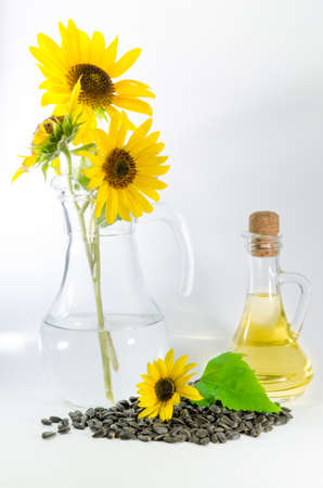 Sunflower and sunflower oil with seeds on white backgroundの写真素材