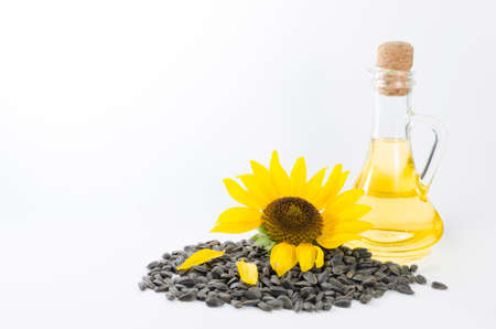 Sunflower and sunflower oil with seeds on white backgroundの写真素材