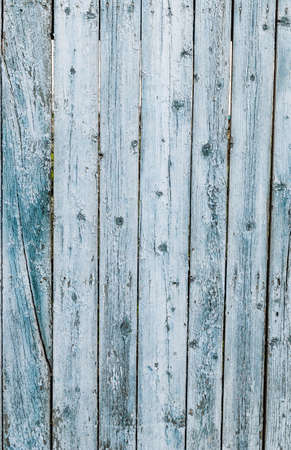 Old wooden fence painted in blue colorの写真素材