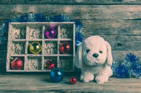 White puppy on the background of Christmas decorations, year of the dog, tintedの写真素材