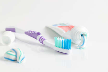 A tube of toothpaste and a toothbrush on white background closeupの写真素材