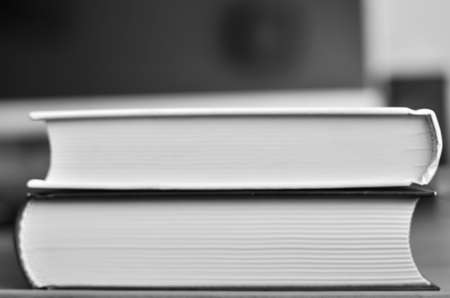 A book with many pages in the foreground, on the background of the computer monitorの写真素材