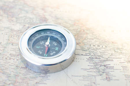 Compass on the old map in the rays of the sunの写真素材