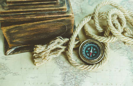 Compass, rope and old box on the old mapの写真素材