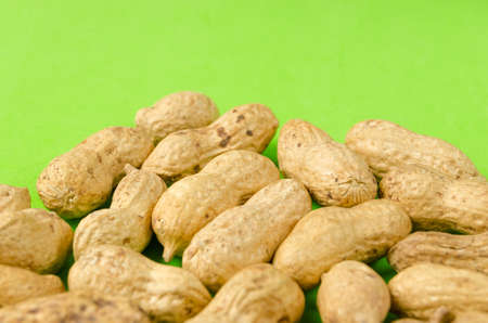 Peanuts on a bright green background.の写真素材