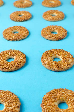 Round cookies with sesame seeds on a bright blue background.Confectionery.の写真素材
