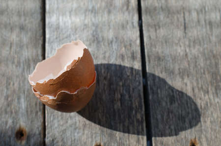 Shell chicken eggs on old wooden background, early in the morning.の写真素材
