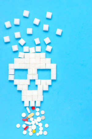 Refined sugar in form of skull with tablets and pills.The concept of healthy eating.の写真素材