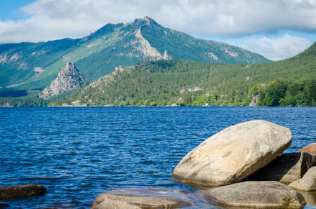 Large boulders in the blue lake against the mountains.Landscape.の写真素材