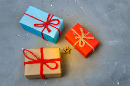 Three Christmas presents on the concrete floor.Holiday, new year and womens day,overhand.の写真素材