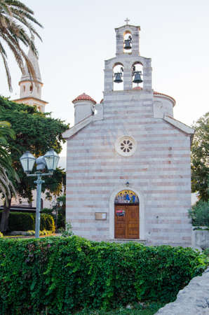 Old Church on the background of palm trees with a tower and bell tower in the old town.の写真素材