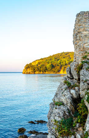Part of the stone wall of the old town against the sea.Early in the morning at sunrise.の写真素材