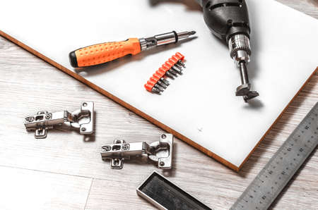 The tool is a drill and a square prepared for marking and inset furniture hinges.