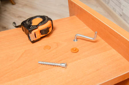 Stool Assembly and tools for marking and assembling furniture, tape measure, screws, key.の写真素材