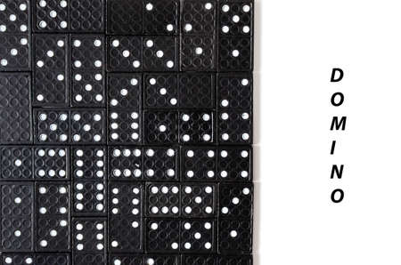 Black dominoes on white background with copy spaceの写真素材