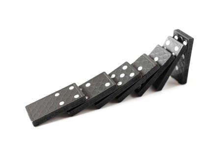 Falling, black Domino bones on white background.