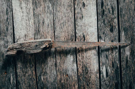 Old, vintage, rusty hacksaw on wooden background.の写真素材