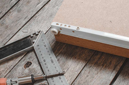 Screwdriver metal measuring corner and assembled furniture box with screwed guides.の写真素材