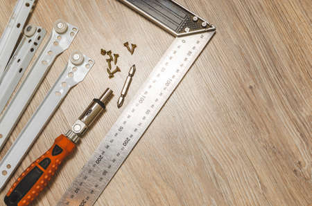 Screwdriver, metal and measuring the area and furniture guides. Furniture accessories.