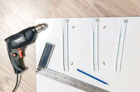 Drill,metallic measuring area, the item of furniture with a stand marked with a pencil furniture guides.の写真素材