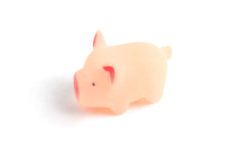 Small rubber, pink pig, toy on white background closeup.の写真素材